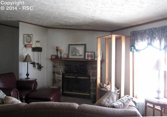 15640 South Lauppe Road Yoder, CO 80864 - Photo 6 of 12 Wood burning fireplace in family room