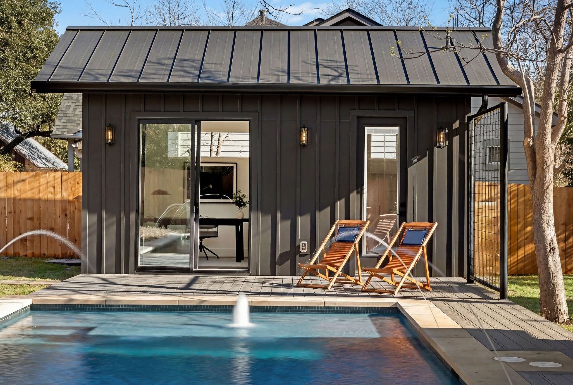 1301 Ruth Avenue Austin, TX 78757 - Photo 17 of 21 Rear view of house with an outdoor structure, an outdoor pool, a metal roof, and a storage structure