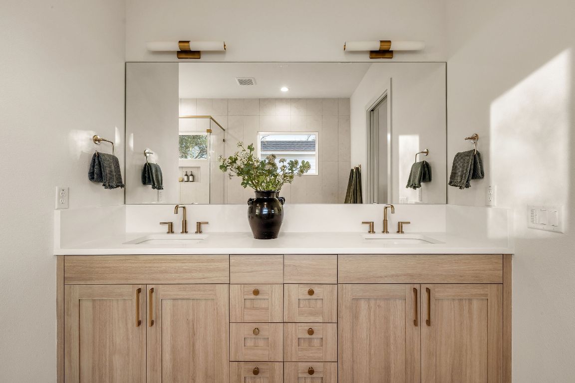 1301 Ruth Avenue Austin, TX 78757 - Photo 9 of 21 Bathroom featuring double vanity and a stall shower