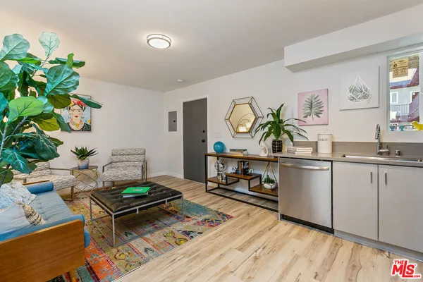 a living room with furniture and a potted plant