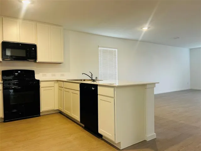 a kitchen with a sink and a bathtub