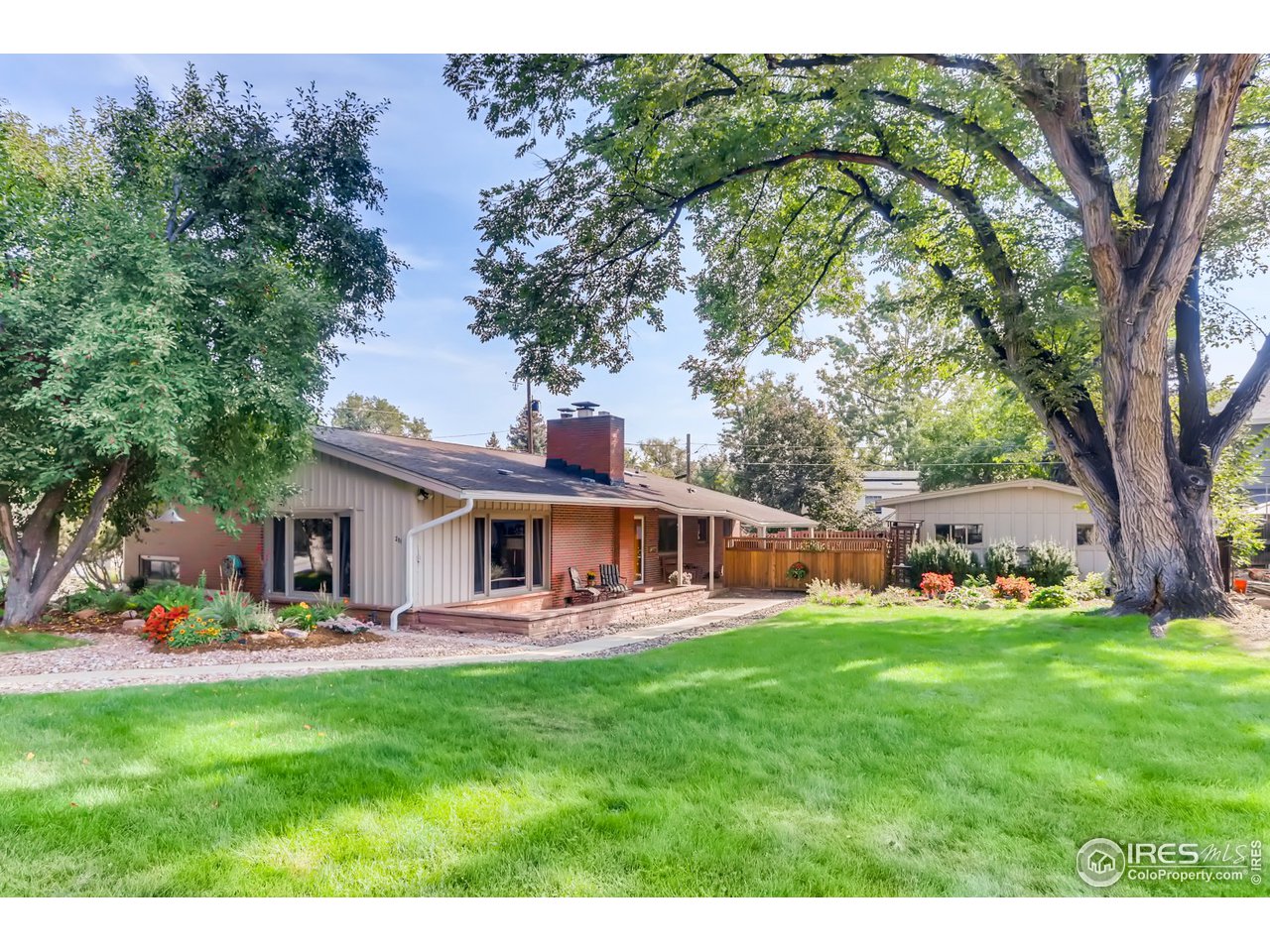 a view of a house with a big yard patio and swimming pool