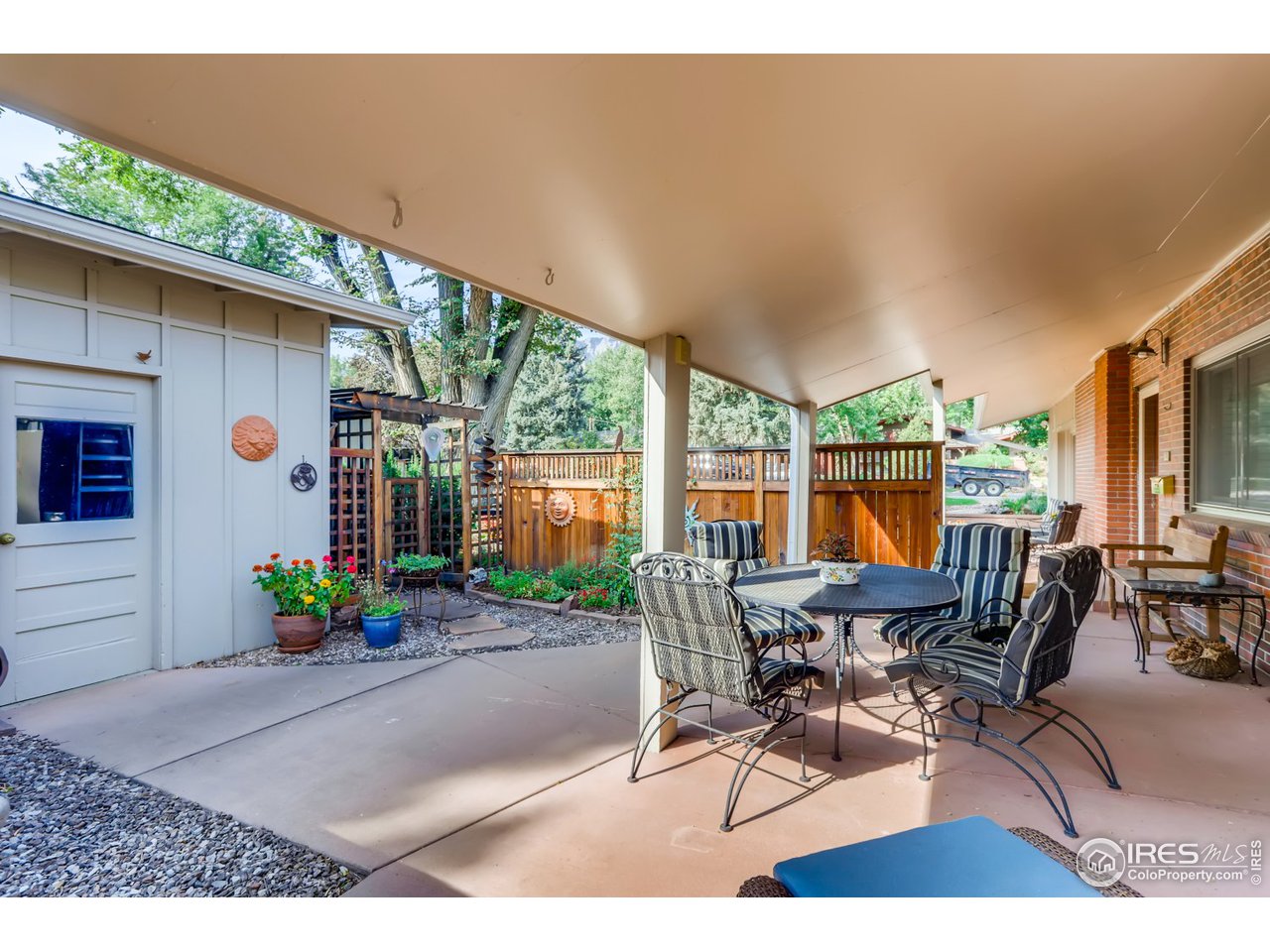 280 Echo Place Boulder, CO 80302 - Photo 31 of 40 a view of a patio with table and chairs potted plants with wooden fence