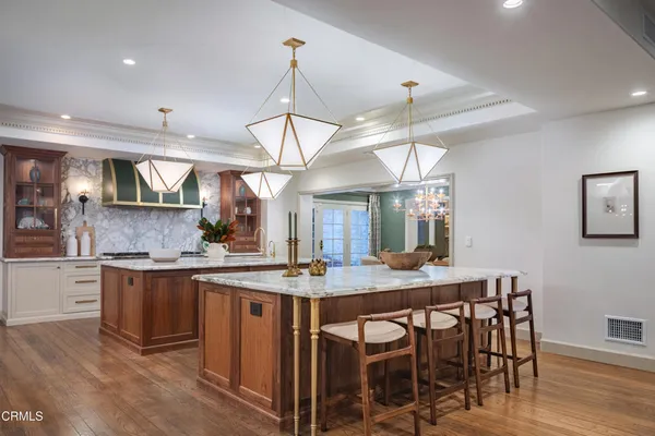 a spacious bathroom with a double vanity sink a toilet a window and tub