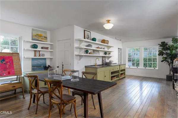 a view of wooden floor and windows in a room