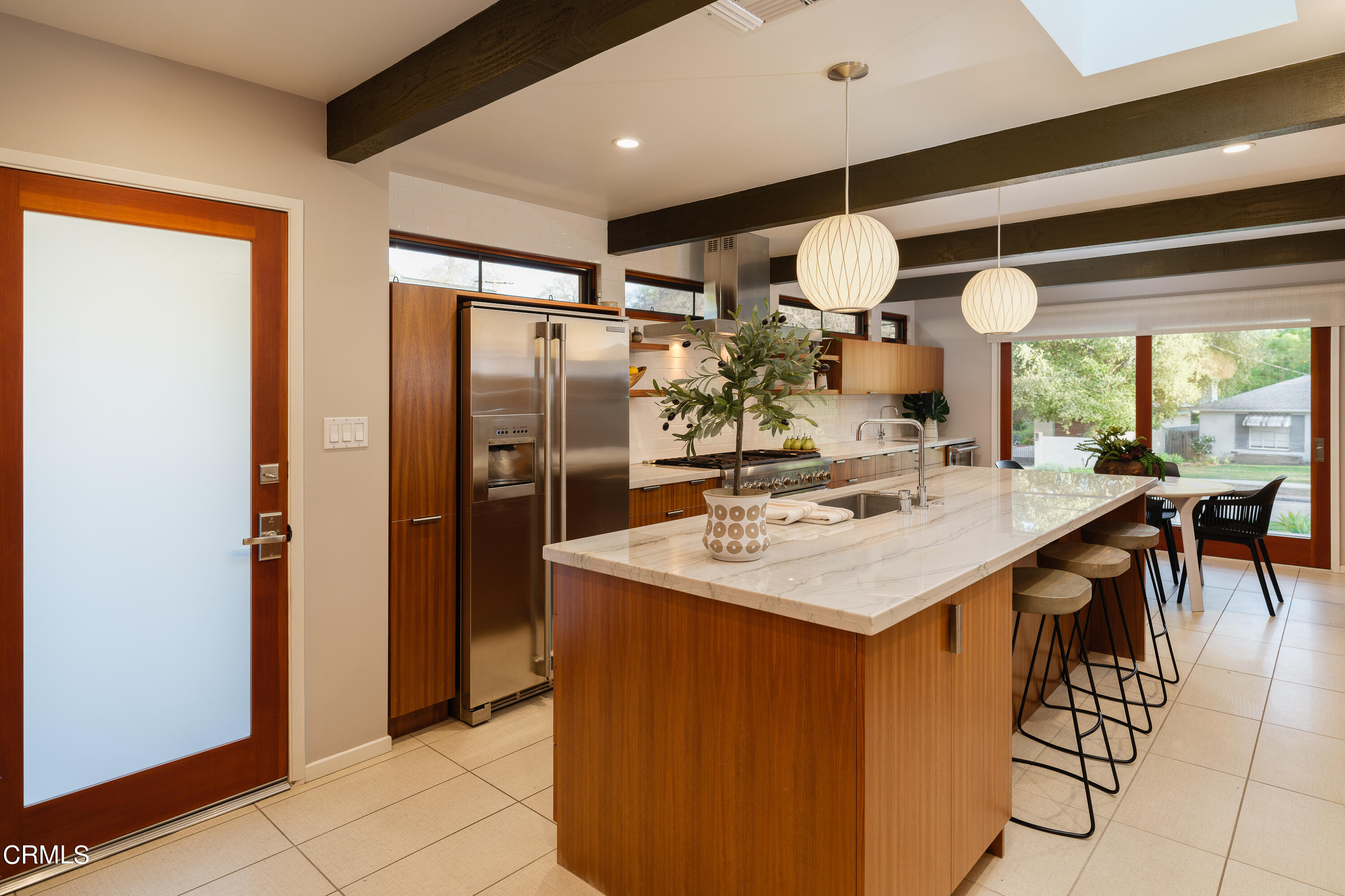 1025 Nithsdale Road Pasadena, CA 91105 - Photo 28 of 73 a kitchen with stainless steel appliances a sink a refrigerator and chairs