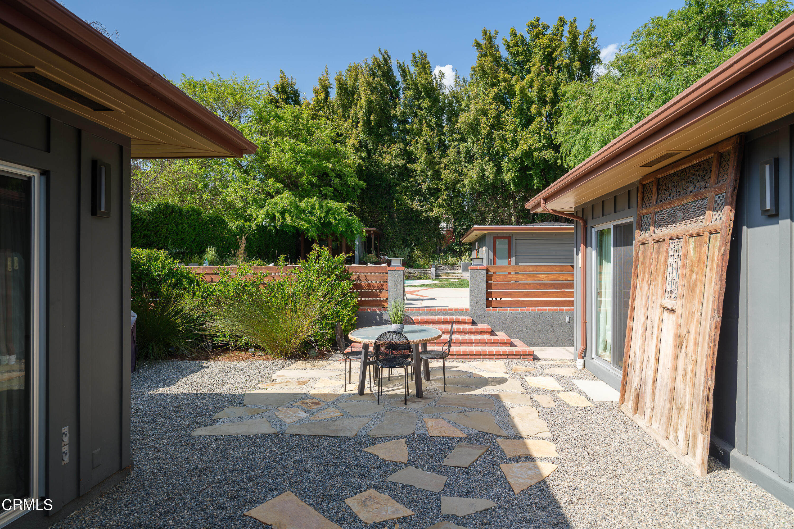 1025 Nithsdale Road Pasadena, CA 91105 - Photo 46 of 73 a view of a patio with table and chairs potted plants with wooden floor and fence