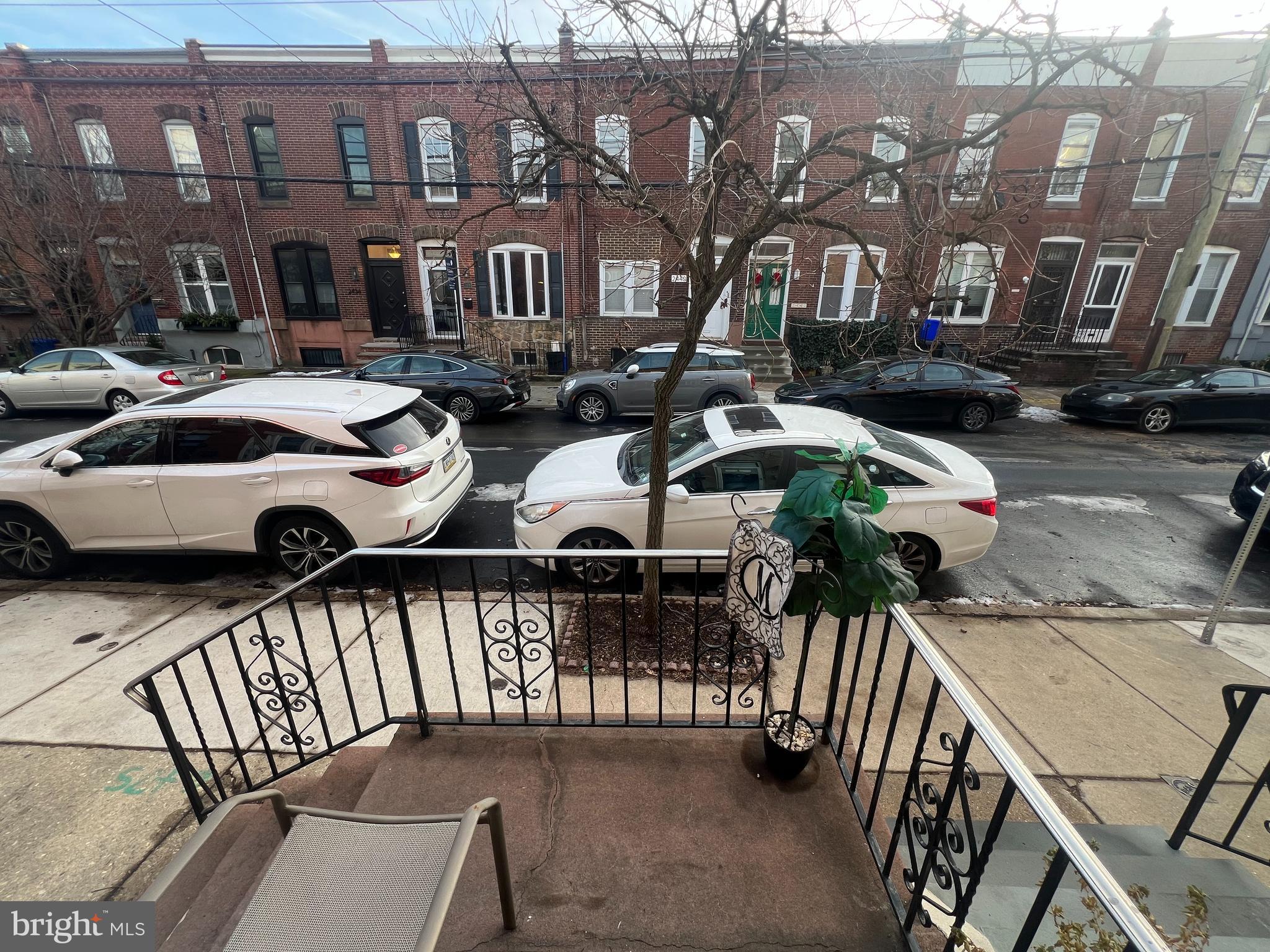 2441 Carpenter Street Philadelphia, PA 19146 - Photo 3 of 34 a view of a brick house with wooden fence
