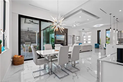 a living room with furniture a flat screen tv and a large window