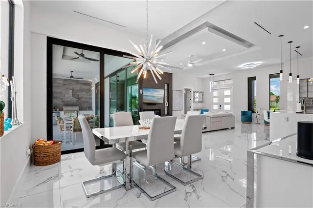 a living room with furniture a flat screen tv and a large window