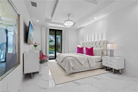 a bedroom with bed and a large mirror