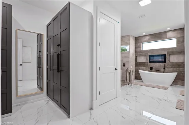 a bathroom with a tub sink shower and mirror