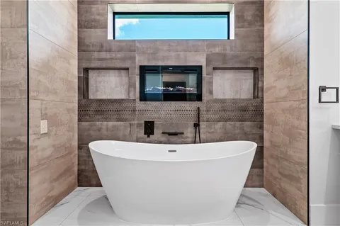 a bathroom with sink mirror and window