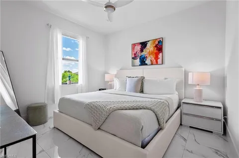 a large white bed in a white room