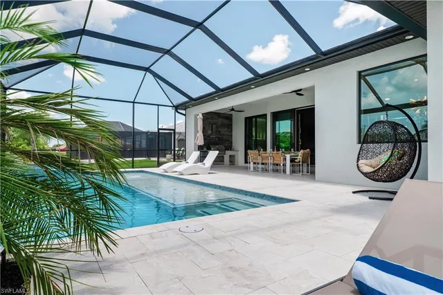 a view of swimming pool with seating area and furniture