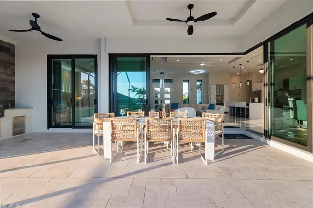 a view of a patio with table and chairs under an umbrella