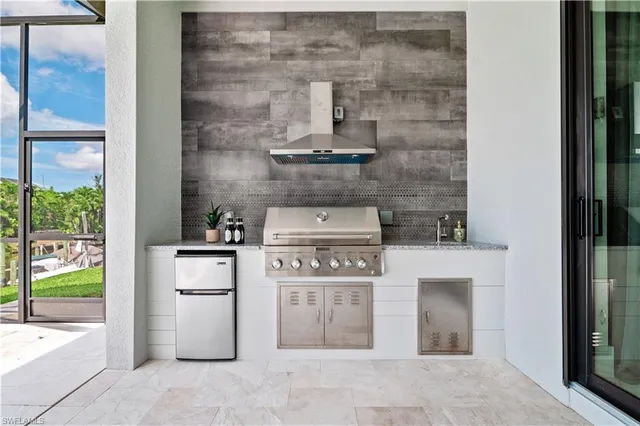 a view of a patio with table and chairs under an umbrella