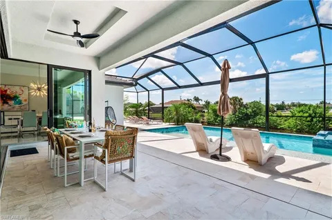 a view of a patio with a dining table and chairs