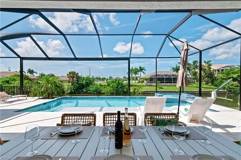 a view of yard from deck with patio