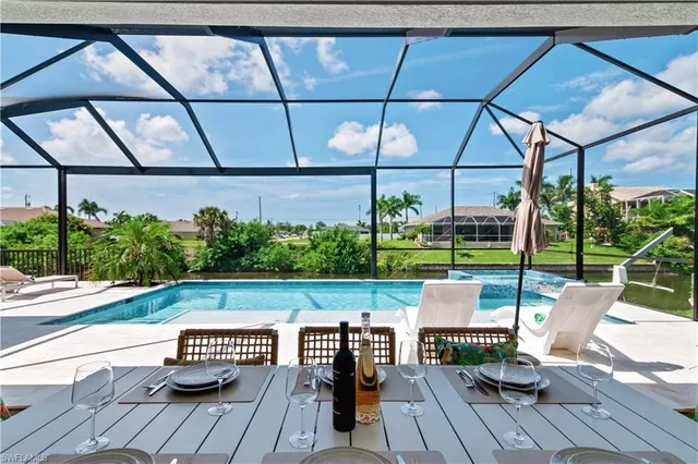 a view of yard from deck with patio