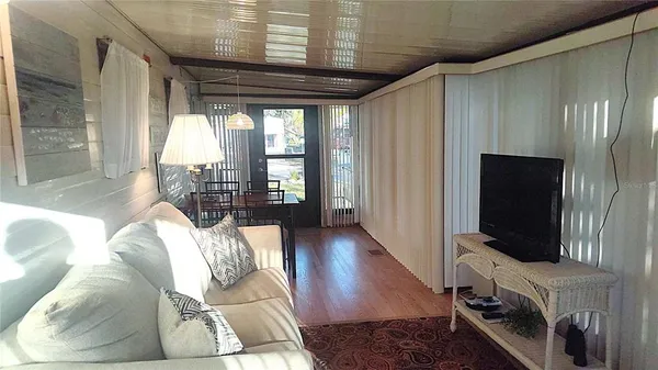 a living room with furniture fireplace and flat screen tv