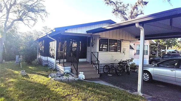 a view of a house with backyard porch and sitting area