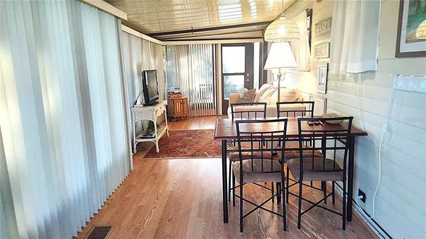 a view of a dining room with furniture and wooden floor