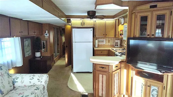 a kitchen with stainless steel appliances kitchen island granite countertop a refrigerator and a stove
