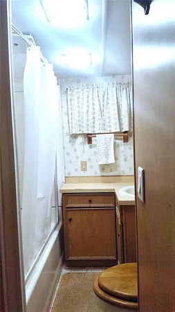 a bathroom with a sink a mirror and a window