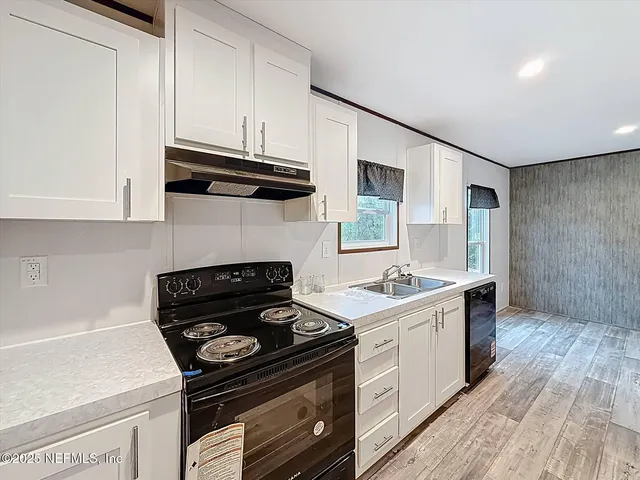 a kitchen with a stove and a sink