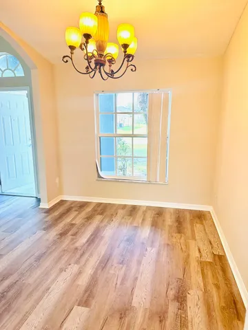 a view of an empty room and wooden floor
