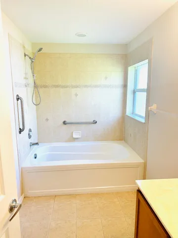 a bathroom with a bathtub and a shower