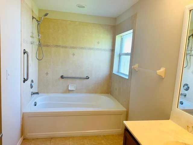 a bathroom with a tub and a shower