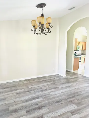 a view of a room with wooden floor and painted walls