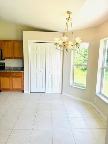 a view of a kitchen with a dishwasher cabinets and a floor to ceiling window