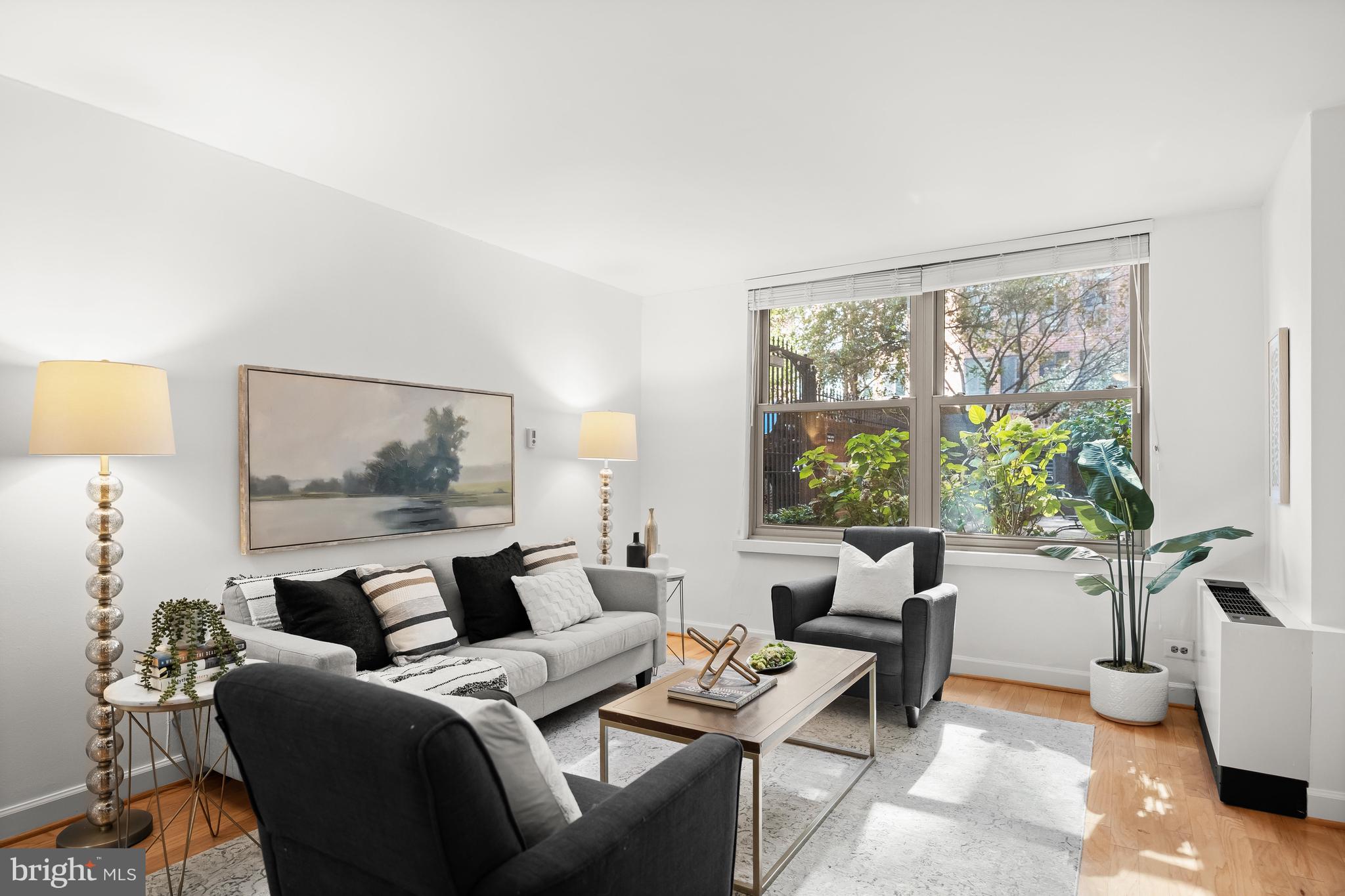 1260 21st Street Northwest, Unit 107 Washington, DC 20036 - Photo 1 of 21 a living room with furniture and a large window