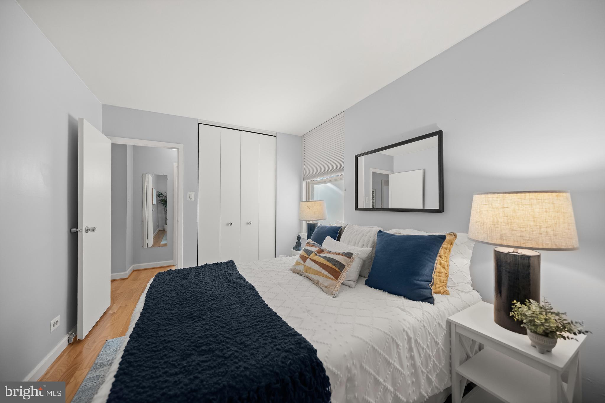 1260 21st Street Northwest, Unit 107 Washington, DC 20036 - Photo 13 of 21 a bedroom with bed and a lamp