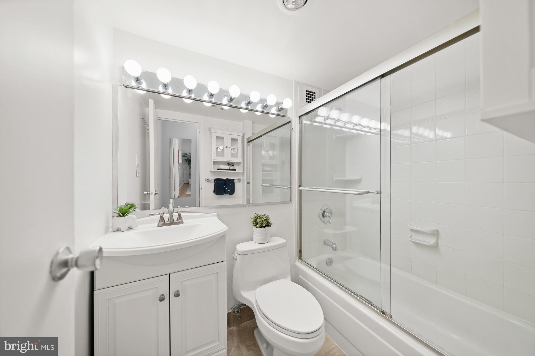 1260 21st Street Northwest, Unit 107 Washington, DC 20036 - Photo 14 of 21 a bathroom with a sink a toilet and shower
