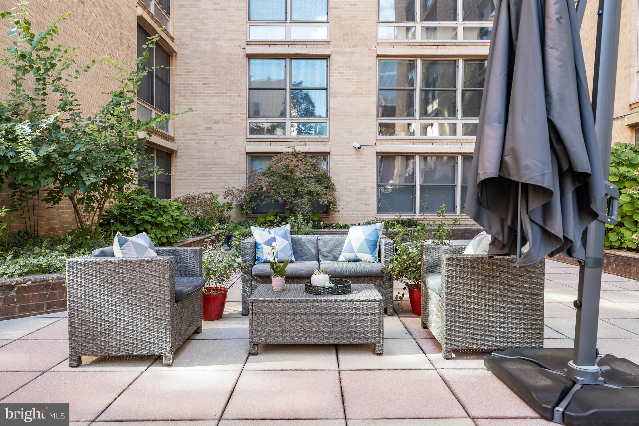 1260 21st Street Northwest, Unit 107 Washington, DC 20036 - Photo 17 of 21 a view of a patio with couches and potted plants