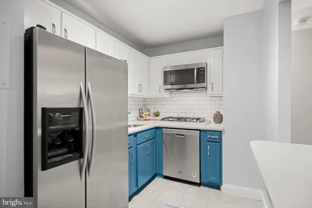 a kitchen with stainless steel appliances a refrigerator and cabinets