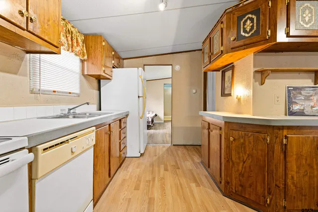 a view of a kitchen with a sink and a wooden floor