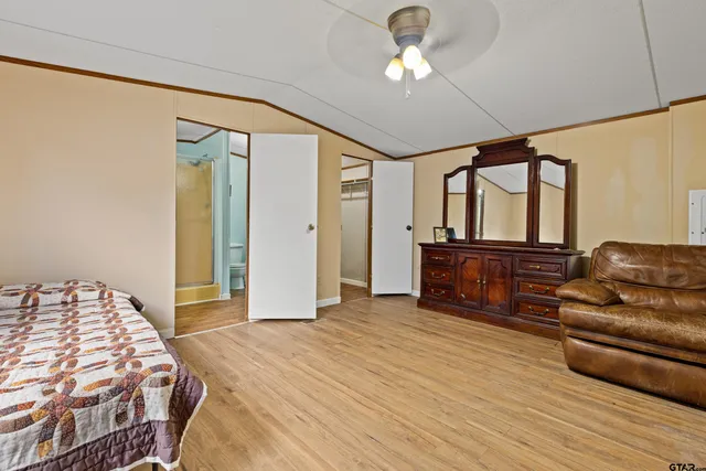 a bedroom with a bed dresser and a window