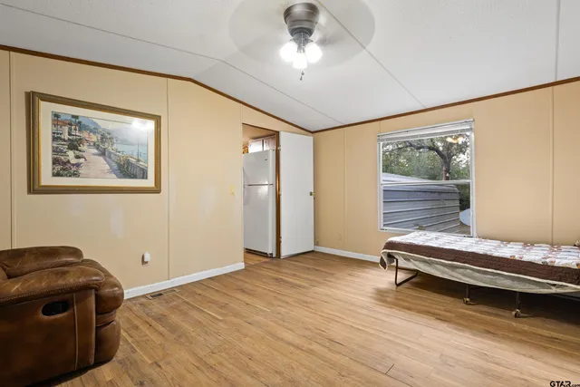 a bedroom with bed and a window