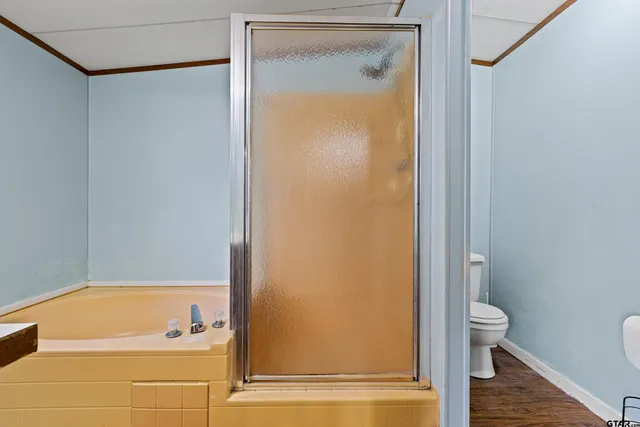 a bathroom with a tub and a shower