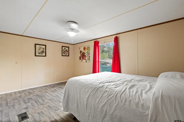 a bedroom with a bed and a large window