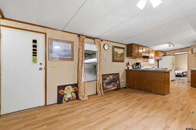 a view of a livingroom with furniture and a kitchen