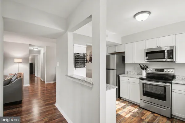 a kitchen with stainless steel appliances a stove microwave and a refrigerator