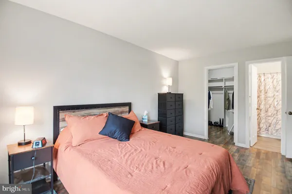 a bedroom with a bed and a lamp