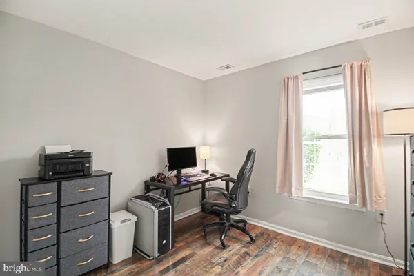 a view of workspace with wooden floor windows