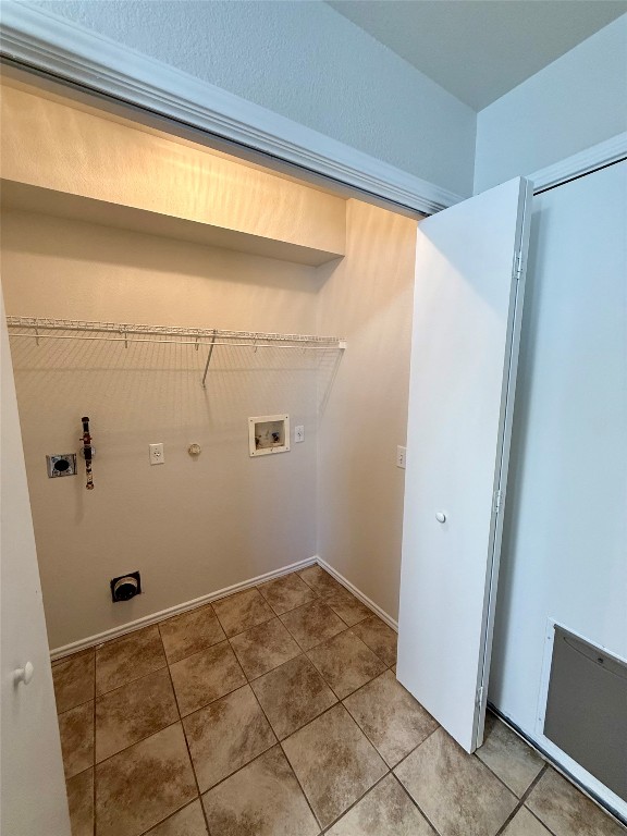 18304 Belfry Pass Manor, TX 78653 - Photo 17 of 26 Laundry area featuring hookup for a washing machine, hookup for a gas dryer, light tile patterned floors, and electric dryer hookup